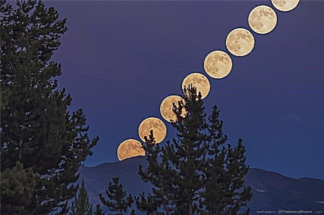 Замедленная съемка: супер луна поднимается над скалистыми горами